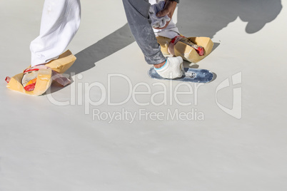 Worker Wearing Sponges On Shoes Smoothing Wet Pool Plaster