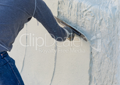 Worker Smoothing Wet Pool Plaster With Trowel