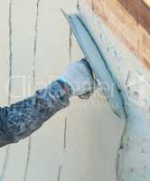 Worker Smoothing Wet Pool Plaster With Trowel