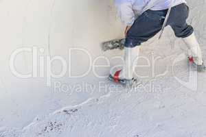 Worker Wearing Spiked Shoes Smoothing Wet Pool Plaster With Trowel