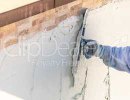 Worker Smoothing Wet Pool Plaster With Trowel