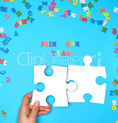 women hand hold  large white puzzles