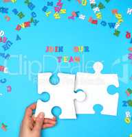 women hand hold  large white puzzles