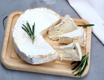 round brie cheese on a wooden board