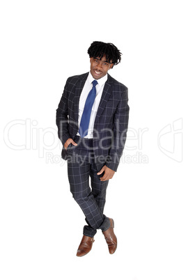 Relaxed black man standing in a suit looking