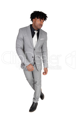 Dancing black man in a gray suit with fussy black hair