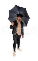 Black man standing in the studio with umbrella