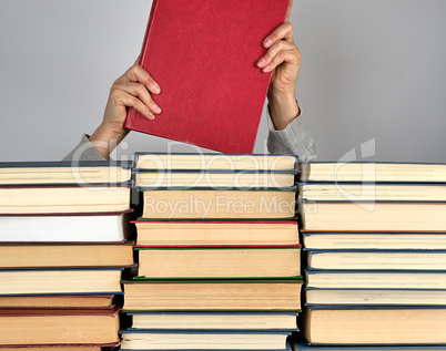 stack of different books on a gray background