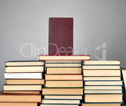 a stack of different books on a gray background