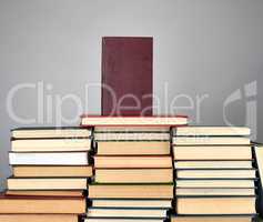 a stack of different books on a gray background