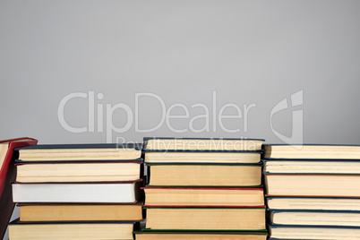 stack of different books on a gray background