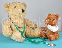 teddy bear with bandaged paw and stethoscope