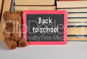 brown teddy bear and empty black board in red frame