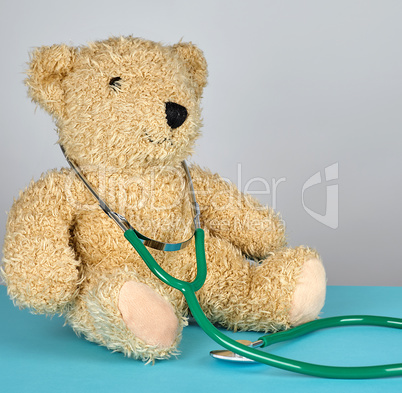 teddy bear and green medical stethoscope
