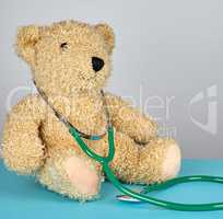 teddy bear and green medical stethoscope