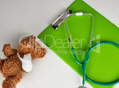 medical stethoscope and green paper holder on a white background