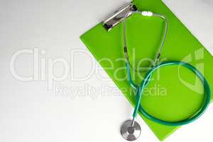 medical stethoscope and green paper holder