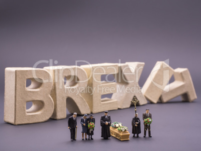 Miniatur people funeral with BREXIT letters in the backround