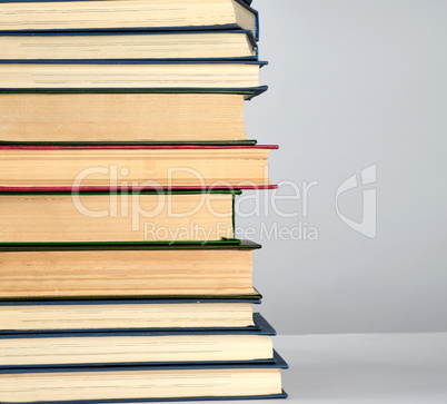 stack of different books on a gray background