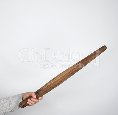 hand holding a wooden rolling pin