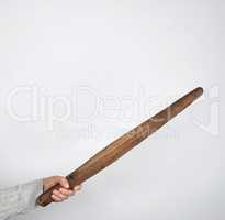 hand holding a wooden rolling pin