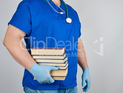 doctor in blue uniform and sterile latex gloves holds in his han