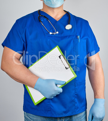 doctor in blue uniform and sterile latex gloves holds clipboard