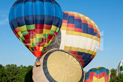 Colorful hot-air balloons ready to get up in flight