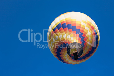 Colorful hot-air balloon in flight seen from below