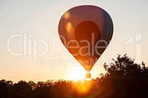 Hot-air balloon in silhouette ready to get up in flight