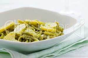 Closeup of linguine pasta with pesto genovese and potatoes