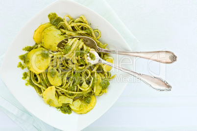 Closeup of linguine pasta with pesto genovese and potatoes over