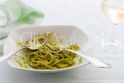 Closeup of eaten linguine pasta with pesto genovese and potatoes