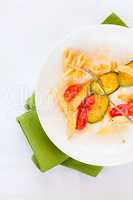 Italian penne pasta with zucchini and cherry tomatoes