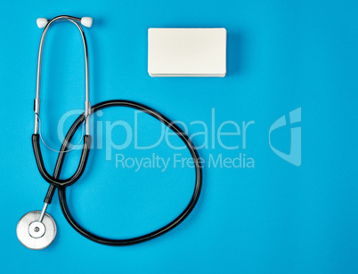 medical stethoscope and empty paper business cards