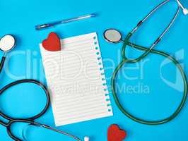 blank white piece of paper in a line and a medical stethoscope