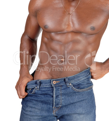 The close up torso of a black man bodybuilder in jeans