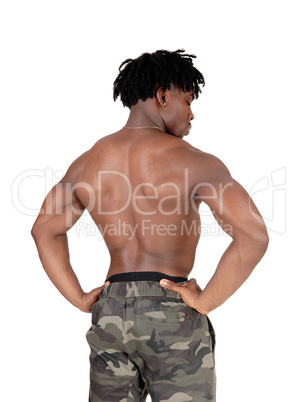 Muscular black man standing shirtless from the back