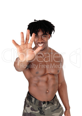 Smiling black man holding hand up saying no