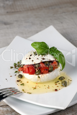 Mozzarella stuffed tomatoes with capers