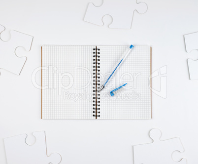 open notebook in a cell and a blue pen