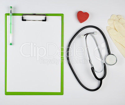 black medical stethoscope and green paper holder