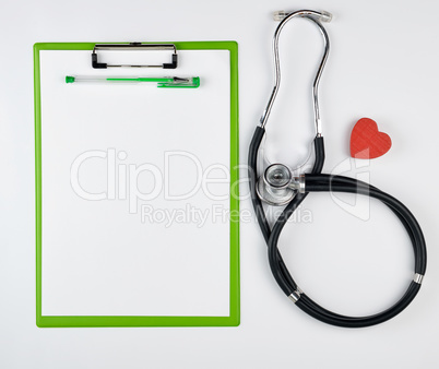 medical stethoscope and green paper holder