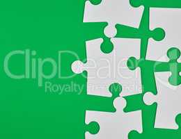 blank white big puzzles on green background