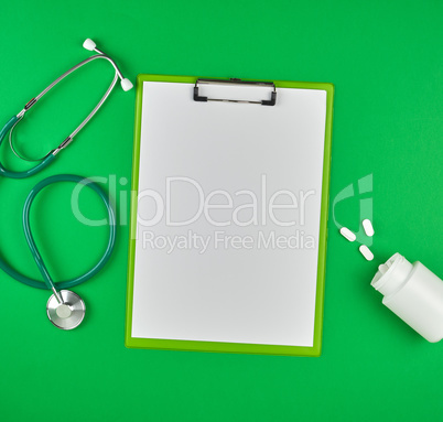 paper holder with empty white sheets, medical stethoscope