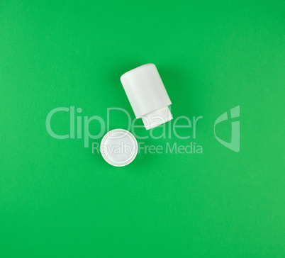 white plastic container for tablets, near the cover