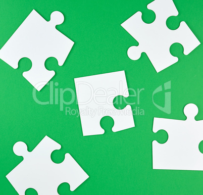 white big puzzles  on a green background
