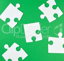 white big puzzles  on a green background