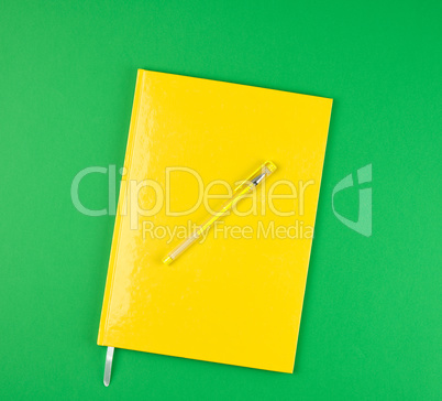 closed notebook and yellow pen