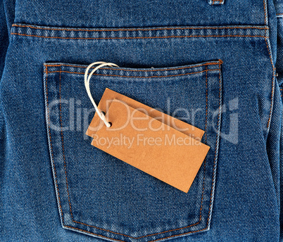 empty paper tag on a rope tied to blue jeans